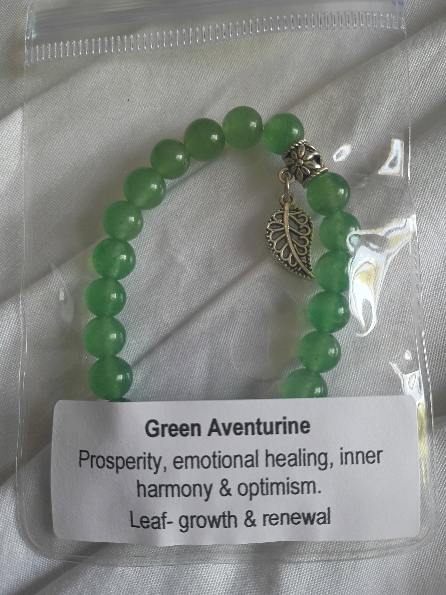 Green adventuring energy bracelet with leaf charm