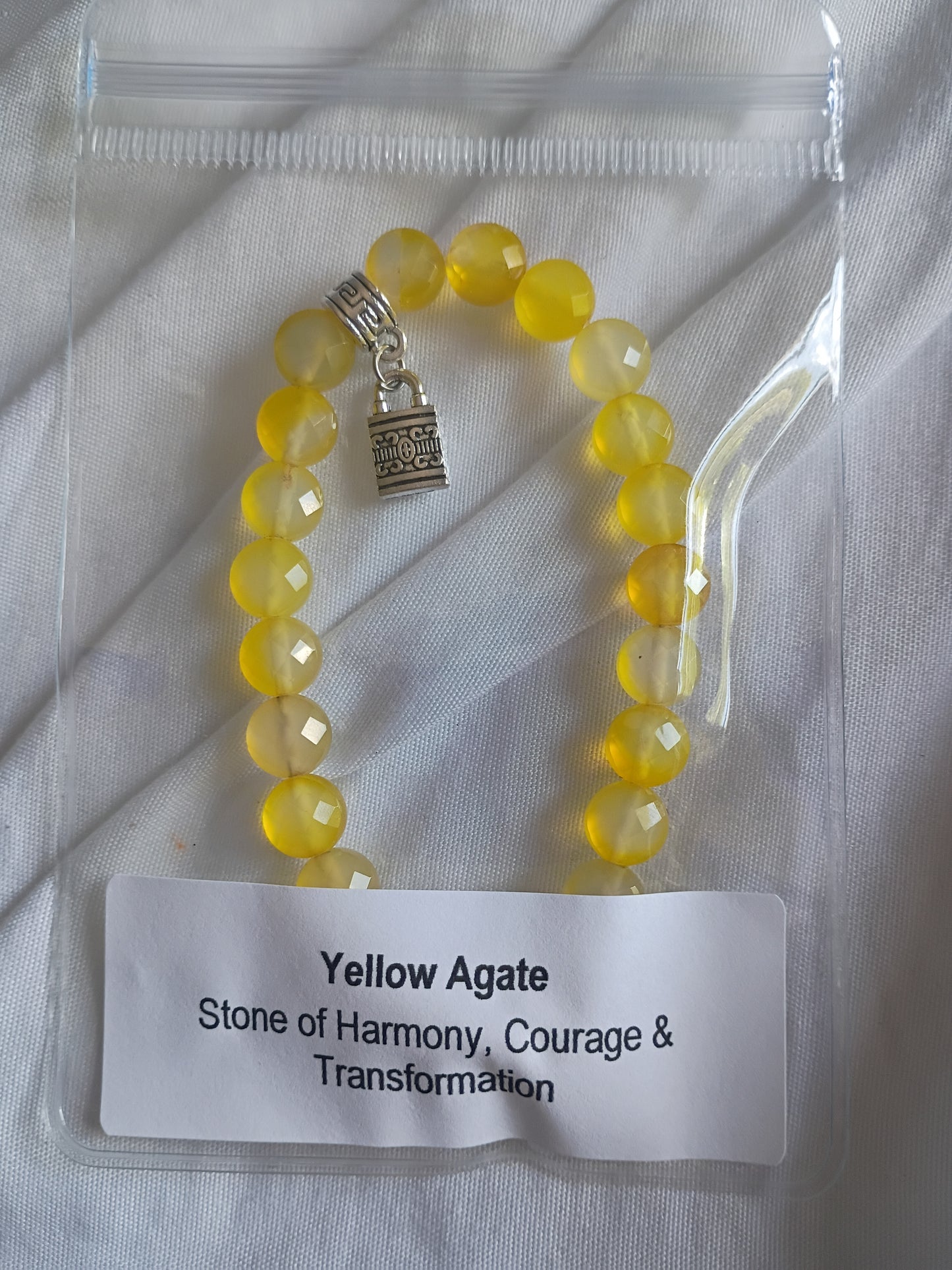 Faceted yellow agate energy bracelet with silver lock charm