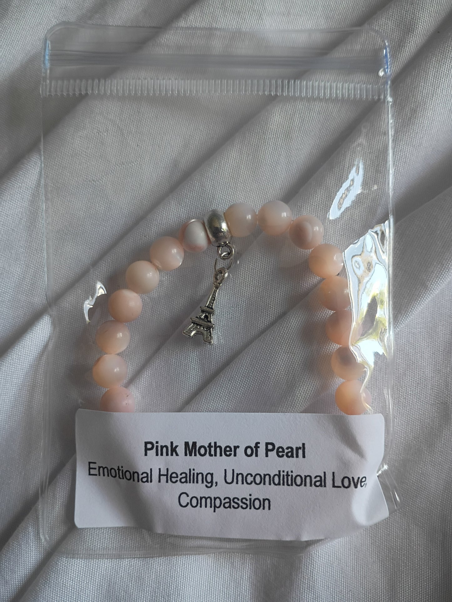 Pink mother of pearl energy bracelet with Eiffel Tower charm