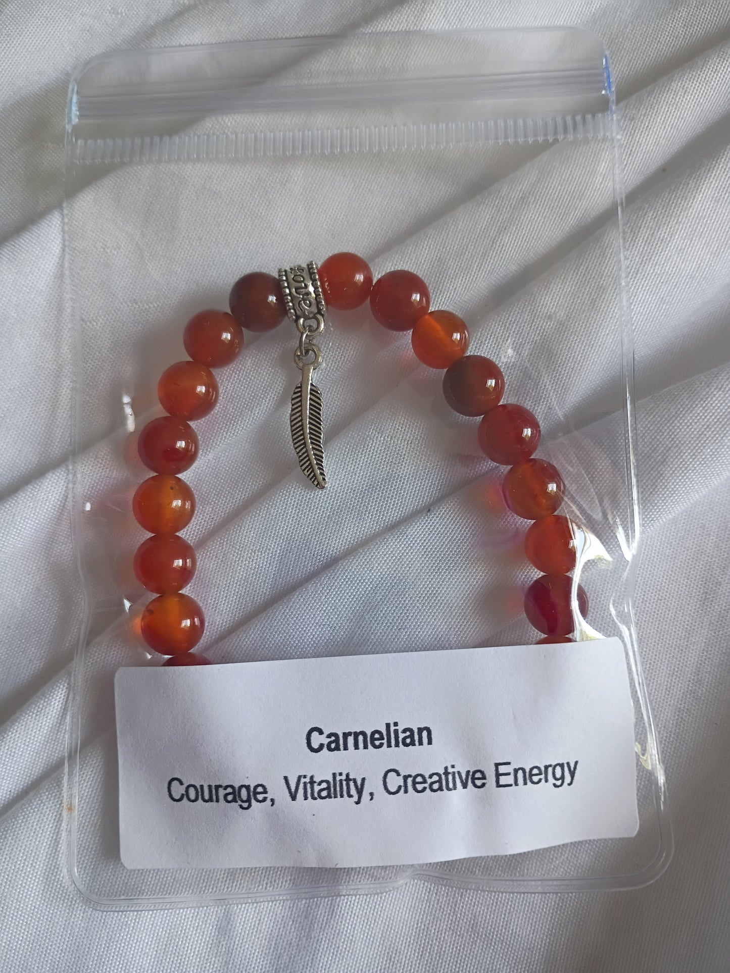 Carnelian energy bracelet with feather charm